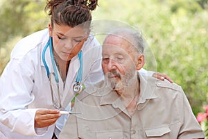 Nurse or doctor and senior patient