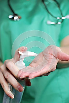 Nurse or Doctor Using Hand Sanitizer