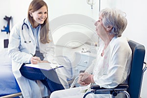 Nurse or doctor writing patient notes in a ward