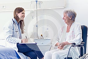 Nurse or doctor writing patient notes in a ward