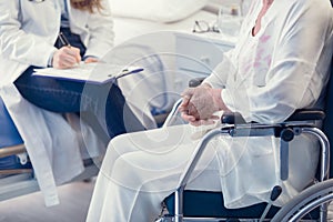 Nurse or doctor writing patient notes in a ward