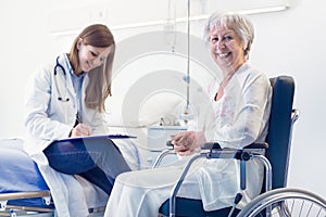 Nurse or doctor writing patient notes in a ward