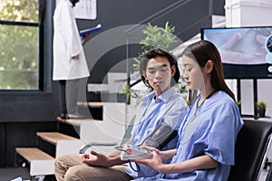 Nurse doing cardiology exam with instrument to measure hypertension and hypotension