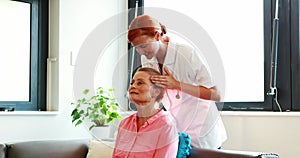 Nurse doing facial massage to her senior patient