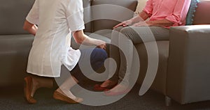 Nurse doing hand massage to her senior patient