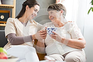 Nurse and elderly lady laughing
