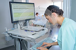 Nurse entering prescription details onto computer
