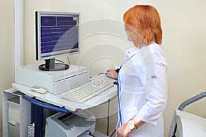 nurse examines cardiogram of patient monitor ECG photo