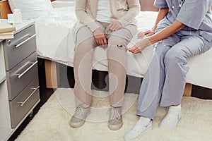 nurse examining patient with reflex hammer