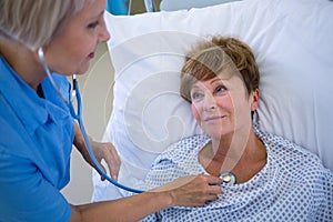 Nurse examining a patient with a stethoscope