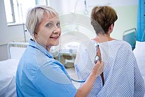 Nurse examining a patient with a stethoscope