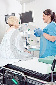 Nurse explaining procedure to patient in hospital surgery