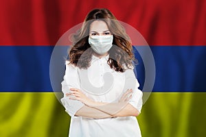 Nurse with face mask against national flag Armenia. Flu epidemic and virus protection concept