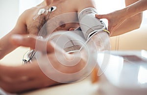 A nurse fastens the tonometer cuffs on the patient`s arm