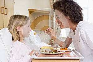 Nurse Feeding Young Girl