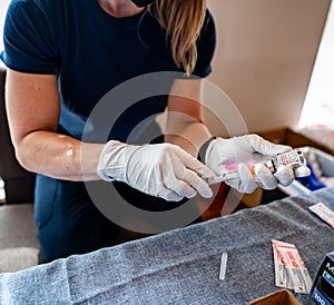 Nurse filling syringe with covid 19 moderna vaccine