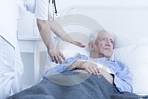 Nurse fluffing pillow of patient