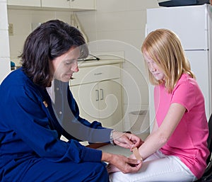 Nurse giving band aid to patient