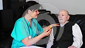 Nurse giving pills to a senior man