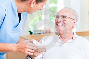 Nurse giving senior man prescription drugs