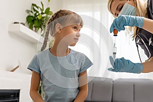 nurse giving vaccination injection to little girl patient