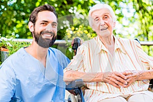 Nurse having chat with senior woman in nursing home