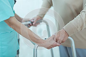 Nurse helping disabled elderly lady