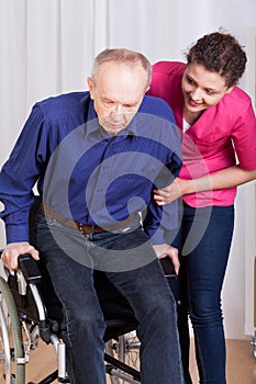 Nurse helping disabled patient