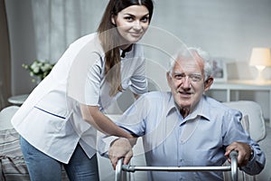 Nurse helping disabled senior man