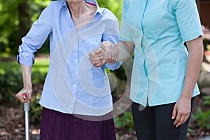 Nurse helping disabled with walking