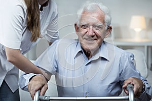 Nurse is helping elder man