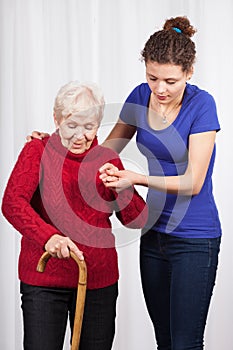 Nurse helping elderly lady walk