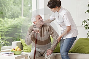 Nurse helping elderly man