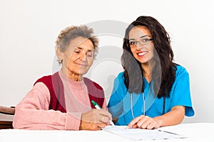 Nurse Helping Elderly Register for Nursing Home