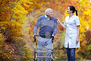 Nurse helping elderly senior man.