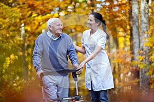 Nurse helping elderly senior man.