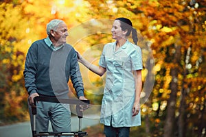 Nurse helping elderly senior man.