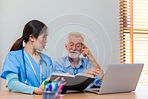 Nurse helping patient for reading note book. woman helping senior man read note book