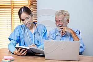 Nurse helping patient for reading note book. woman helping senior man read note book