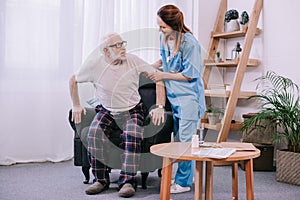 Nurse helping senior man to