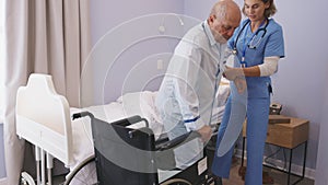 Nurse helping senior patient at clinic