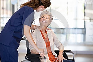 Nurse helping senior patient on wheelchair