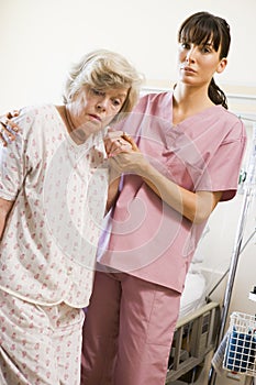 Nurse Helping Senior Woman To Walk