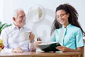 Nurse helping to read a book