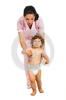 Nurse helping toddler to walk