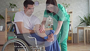 Nurse helps in the rehabilitation of a disabled person in a wheelchair