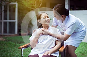 Nurse holding hands to elderly Asian woman with Alzheimer disease,Positive thinking,Happy and smiling,Take care and support concep