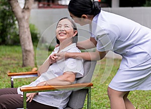 Nurse holding hands to elderly Asian woman with Alzheimer disease,Positive thinking,Happy and smiling,Take care and support concep