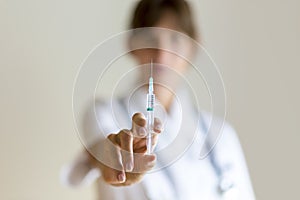 Nurse holding an injection needle photo