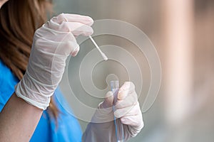 Nurse holding nasal swab laboratory test for Coronavirus or COVID-19